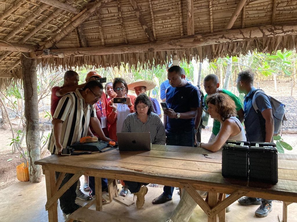 Participants gathered around a laptop during the scanner training in Madagascar